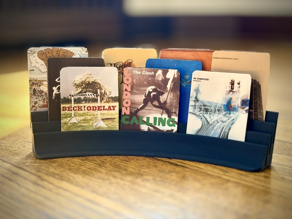 Album cards displayed on a table showing various album covers